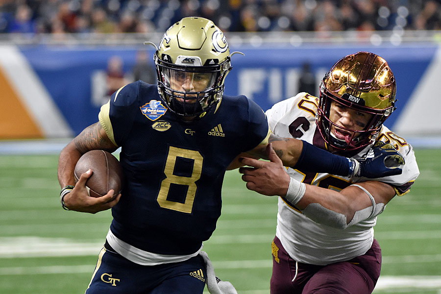 Georgia Tech back-up QB Tobias Oliver (8) got some minutes under centre late in the game against Minnesota at the 2018 Quick Lane Bowl. Oliver, seen avoiding Julian Huff, carried the ball 9 times for 69 yards in the 34-10 loss.Photo by Ian Shalapata.